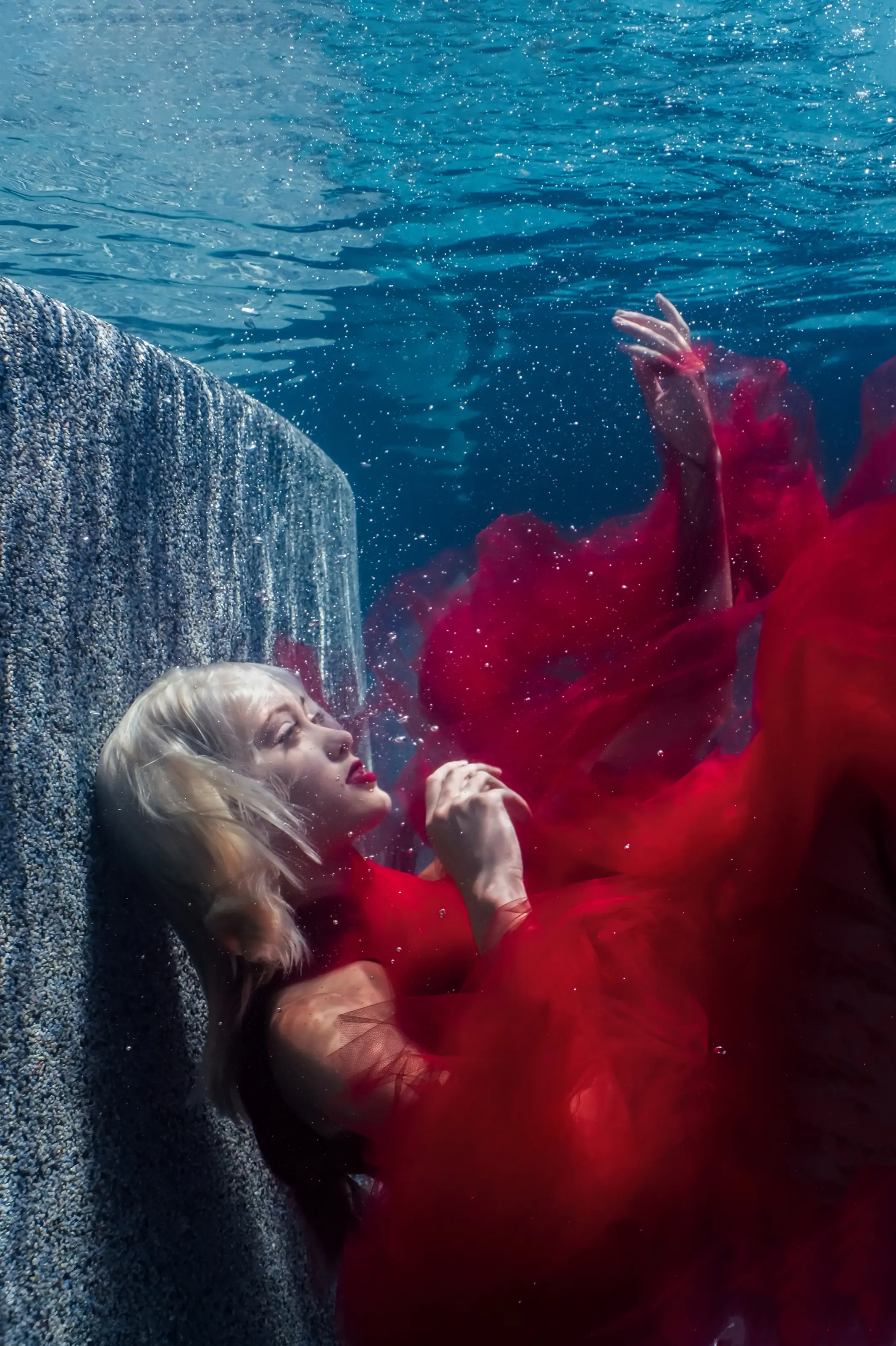 Red fabric moving around a submerged figure